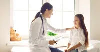DNP-prepared nurse with a patient